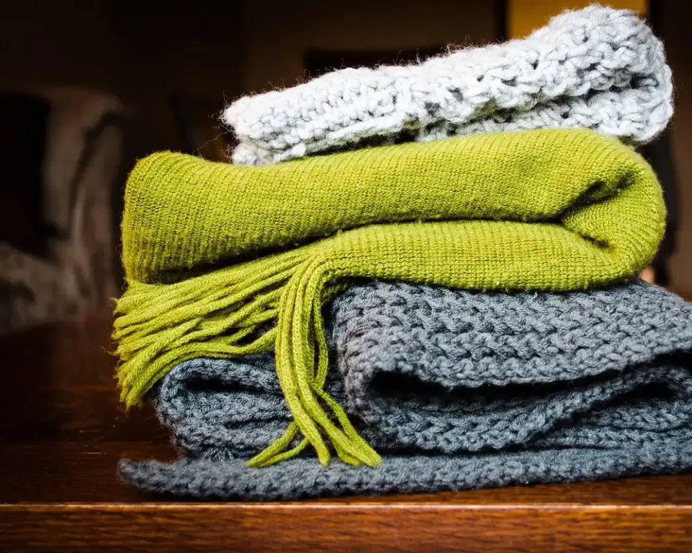 Stack of folded wool knit scarves