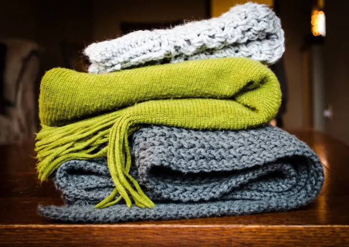 Stack of folded wool knit scarves