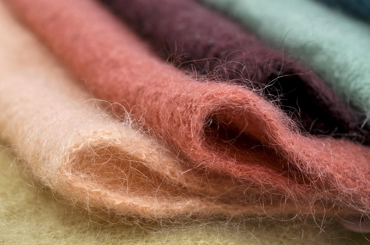 Draped folds of soft, fine mohair or angora fabric with a long, fuzzy pile and sheer texture